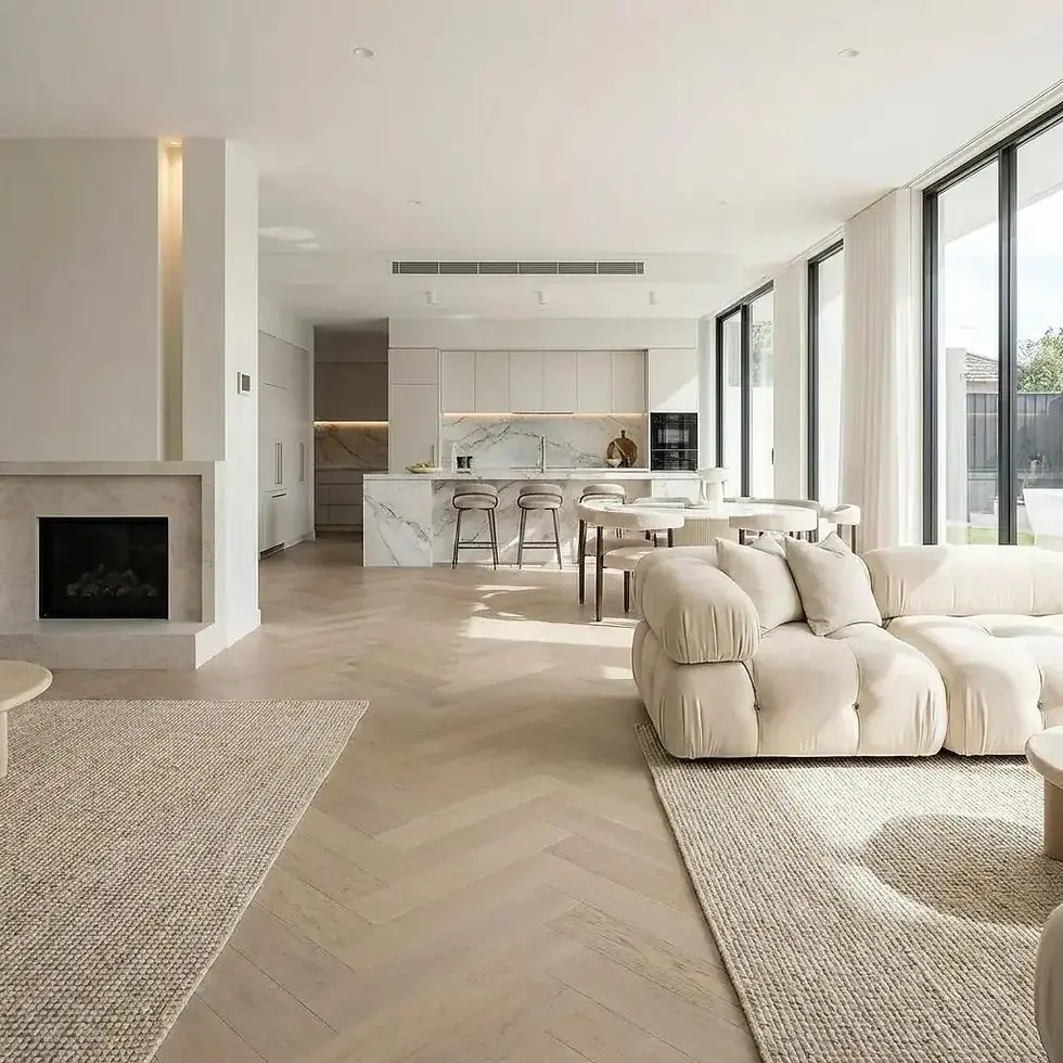 Light oak herringbone hardwood floor in an open living and kitchen space