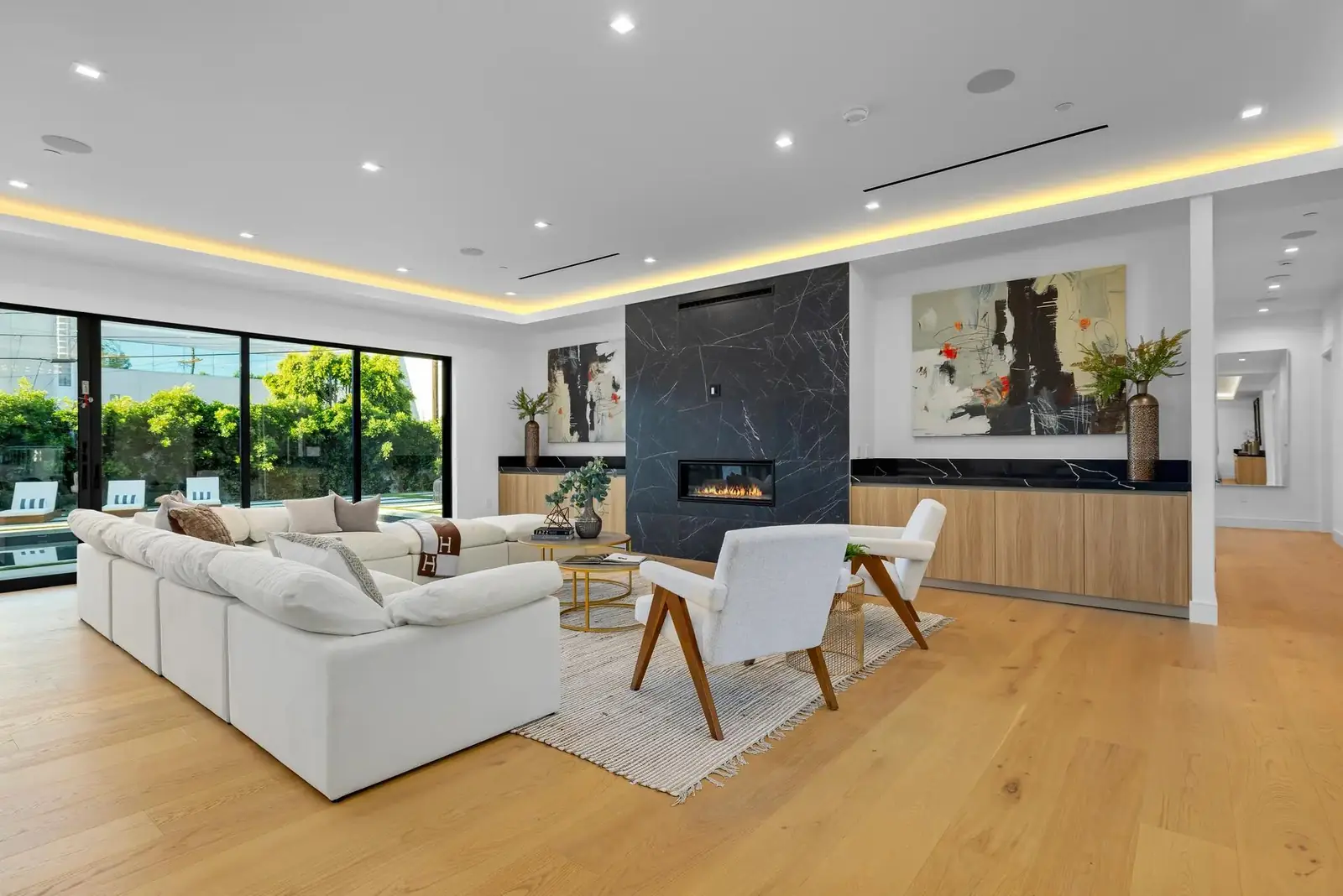 Wide-plank golden oak hardwood floor in a modern family room with fireplace